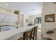 Open-concept kitchen featuring white cabinets, a breakfast bar, and stylish decor at 11120 Marigold Dr, Lakewood Ranch, FL 34202