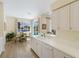 Well-lit kitchen with white cabinetry, a breakfast bar, and a view to the outdoor pool area at 11120 Marigold Dr, Lakewood Ranch, FL 34202