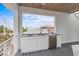 A functional kitchenette with a sink, refrigerator, and cabinets on the deck at 112 Elm Ave, Anna Maria, FL 34216