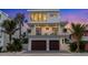 Modern two-story home featuring a two-car garage, balconies, and contemporary design at 112 Elm Ave, Anna Maria, FL 34216