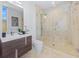 Bathroom featuring a glass-enclosed shower, and modern sink and faucet with a neutral color palette at 115 N Bay Blvd, Anna Maria, FL 34216