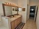 Bright bathroom with a double sink vanity, a large mirror, and decorative wall hangings at 1155 Millbrook Cir, Bradenton, FL 34212