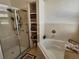 Well lit bathroom features a soaking tub, shower and shelving for optimal storage at 1155 Millbrook Cir, Bradenton, FL 34212
