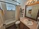 Well-lit bathroom features a shower-tub combo, a mirrored vanity, and natural colored decor at 1155 Millbrook Cir, Bradenton, FL 34212