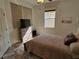 Cozy bedroom featuring wood-look floors, a neutral color scheme and ample natural light from the large window at 1155 Millbrook Cir, Bradenton, FL 34212