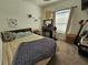 Well-lit bedroom features a window and decor shelves, as well as a cozy bed and a vanity at 1155 Millbrook Cir, Bradenton, FL 34212
