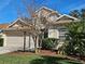 Charming two-story home with a well-manicured lawn, complemented by a two-car garage and traditional design at 1155 Millbrook Cir, Bradenton, FL 34212
