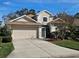 Charming two-story home with a well-manicured lawn, complemented by a two-car garage and traditional design at 1155 Millbrook Cir, Bradenton, FL 34212