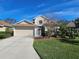 Charming two-story home with a well-manicured lawn, complemented by a two-car garage and traditional design at 1155 Millbrook Cir, Bradenton, FL 34212