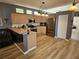 Bright kitchen features stainless steel appliances, light wood cabinets, breakfast bar and wood flooring at 1155 Millbrook Cir, Bradenton, FL 34212