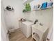 Functional laundry room with white appliances, ample storage space, and a utility sink at 1155 Millbrook Cir, Bradenton, FL 34212
