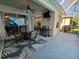 Covered patio with ceiling fan, table, chairs and a grill at 1155 Millbrook Cir, Bradenton, FL 34212