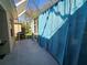 Enclosed patio area, featuring bright blue curtains that provide shade and privacy for relaxing or entertaining at 1155 Millbrook Cir, Bradenton, FL 34212