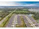 Expansive aerial view of a community with meticulously designed homes, complemented by lush landscaping and serene ponds at 12476 Oak Hill Way, Parrish, FL 34219