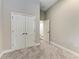 Neutral bedroom featuring plush carpet, closet, and door leading to hallway, creates a cozy and inviting retreat at 12476 Oak Hill Way, Parrish, FL 34219