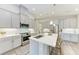 Modern kitchen featuring stainless steel appliances, a center island with seating, and gray cabinetry at 12476 Oak Hill Way, Parrish, FL 34219