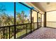 Screened outdoor patio with brick floor, perfect for relaxing and enjoying the view at 1318 3Rd Street E Cir, Palmetto, FL 34221