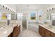 Spacious bathroom boasts dual sinks, tub, shower, tile floors and bright natural light at 1318 3Rd Street E Cir, Palmetto, FL 34221