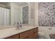 Well-lit bathroom features granite countertop, stylish faucet, and shower-tub combo at 1318 3Rd Street E Cir, Palmetto, FL 34221