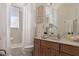 Bright bathroom featuring a large mirror, vanity with drawers, and shower-tub combination at 1318 3Rd Street E Cir, Palmetto, FL 34221