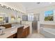 Spacious bathroom with a double vanity, soaking tub, separate shower, and large mirror at 1318 3Rd Street E Cir, Palmetto, FL 34221