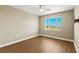 Comfortable bedroom with hardwood floors, ceiling fan, and a large window for natural light at 1318 3Rd Street E Cir, Palmetto, FL 34221