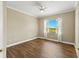 Inviting bedroom with hardwood floors, ceiling fan, and a large window for natural light at 1318 3Rd Street E Cir, Palmetto, FL 34221