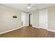 A spacious bedroom featuring wood floors, a ceiling fan, and white doors in a well-lit home at 1318 3Rd Street E Cir, Palmetto, FL 34221