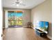 Light filled bedroom featuring wood floors and a sliding door to a patio with natural views at 1318 3Rd Street E Cir, Palmetto, FL 34221