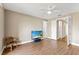 Light filled bedroom featuring wood floors, a chair, and a wall mounted television at 1318 3Rd Street E Cir, Palmetto, FL 34221