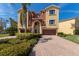 Charming three-story villa showcasing a two-car garage and lush landscaping, creating great curb appeal at 1318 3Rd Street E Cir, Palmetto, FL 34221