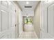 Hallway with tile floor leading to a living area with a sliding glass door at 1318 3Rd Street E Cir, Palmetto, FL 34221