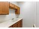 Laundry area featuring wooden cabinets, countertop space, and a utility sink for added convenience at 1318 3Rd Street E Cir, Palmetto, FL 34221