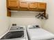 Convenient laundry room featuring a washer, dryer, and storage cabinets for an organized space at 1318 3Rd Street E Cir, Palmetto, FL 34221