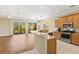 Living room, dining, and kitchen combo with wood floors, granite counters and stainless appliances at 1318 3Rd Street E Cir, Palmetto, FL 34221