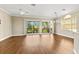 Bright living room with hardwood floors, ceiling fan, and sliding doors to balcony at 1318 3Rd Street E Cir, Palmetto, FL 34221