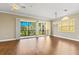 Bright living room with hardwood floors, ceiling fan, and sliding doors to balcony at 1318 3Rd Street E Cir, Palmetto, FL 34221