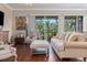 Comfortable living room with cozy seating, wood floors, and access to a balcony at 1318 3Rd Street E Cir, Palmetto, FL 34221