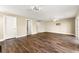 Open living room area features wood floors, neutral walls, and ceiling fan at 1318 3Rd Street E Cir, Palmetto, FL 34221