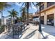 Inviting outdoor dining space with palm trees, street lamps, and comfortable seating arrangements at 1318 3Rd Street E Cir, Palmetto, FL 34221