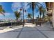 Outdoor patio area with tables, chairs, and palm trees, perfect for enjoying the Florida weather at 1318 3Rd Street E Cir, Palmetto, FL 34221