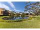 Scenic view of a community pond reflecting nearby homes and lush landscaping on a clear day at 1318 3Rd Street E Cir, Palmetto, FL 34221