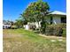 Spacious backyard with lush lawn, mature trees, and boat dock access, perfect for outdoor enjoyment at 1428 Pine Island Ct, Punta Gorda, FL 33950