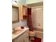 Bathroom featuring tiled walls and shower, and a wood-finished medicine cabinet above the toilet at 1428 Pine Island Ct, Punta Gorda, FL 33950