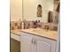 Well-lit bathroom featuring a tiled backsplash and countertop, and a decorative inset shelving in the wall at 1428 Pine Island Ct, Punta Gorda, FL 33950