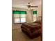Bedroom with a ceiling fan, blind-covered windows, and a bed with a patterned quilt at 1428 Pine Island Ct, Punta Gorda, FL 33950