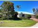 Charming single story home with a green roof, well-manicured lawn and mature landscaping at 1428 Pine Island Ct, Punta Gorda, FL 33950