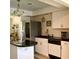Functional kitchen featuring white cabinets, black countertops, and stainless steel refrigerator at 1428 Pine Island Ct, Punta Gorda, FL 33950