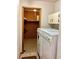 Bright laundry area with washer, dryer, storage cabinets, and a closet for cleaning supplies at 1428 Pine Island Ct, Punta Gorda, FL 33950