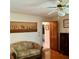Cozy living room featuring hardwood floors, a comfortable couch, and stylish decorations at 1428 Pine Island Ct, Punta Gorda, FL 33950